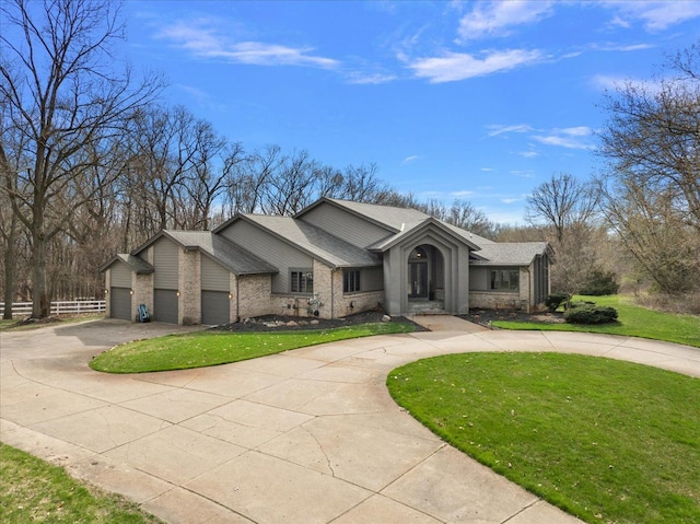 1194 Eagle Nest, Milford, MI 48381 - view of front facade with curved driveway, a front yard, a shingled roof, and a garage