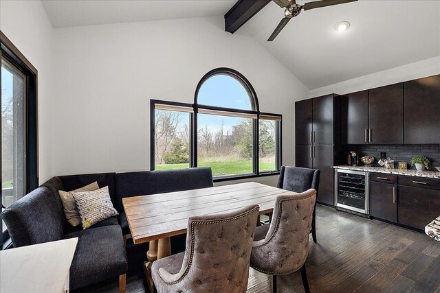 1194 Eagle Nest, Milford, MI 48381 - dining area with wine cooler, a bar, healthy amount of natural light, dark wood finished floors, and beamed ceiling