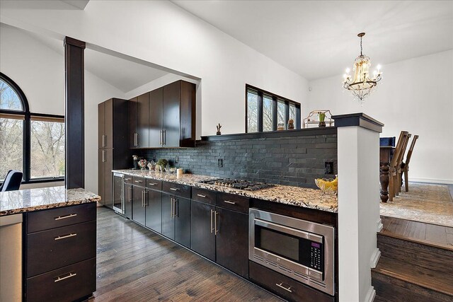 1194 Eagle Nest, Milford, MI 48381 - kitchen featuring stainless steel appliances, dark wood-type flooring, a chandelier, tasteful backsplash, and vaulted ceiling