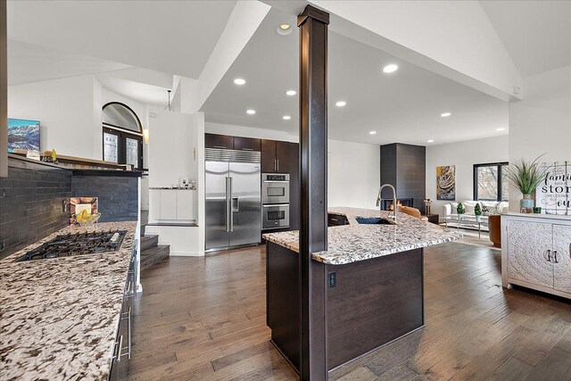 1194 Eagle Nest, Milford, MI 48381 - kitchen with appliances with stainless steel finishes, a sink, dark brown cabinetry, dark wood-type flooring, and modern cabinets