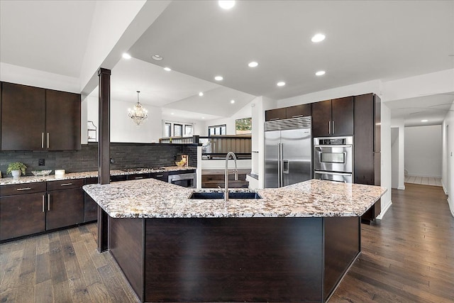 1194 Eagle Nest, Milford, MI 48381 - kitchen with a sink, appliances with stainless steel finishes, dark brown cabinetry, backsplash, and dark wood finished floors