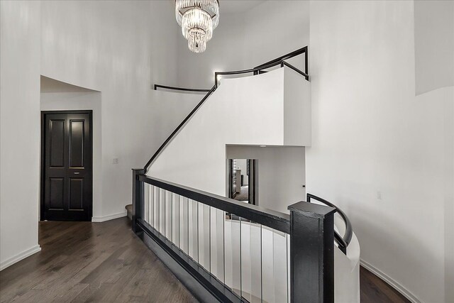 1194 Eagle Nest, Milford, MI 48381 - stairway with baseboards, wood finished floors, a chandelier, and a high ceiling