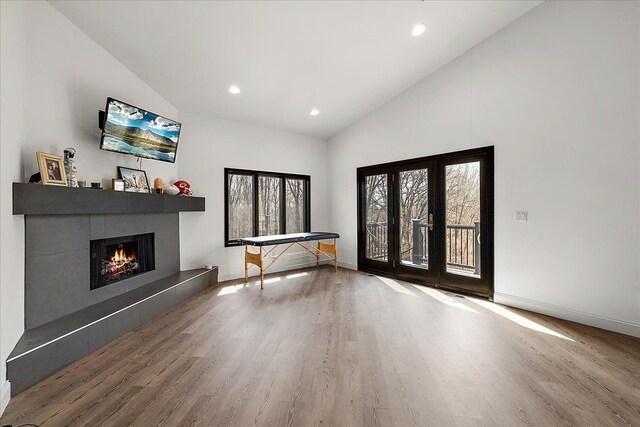 1194 Eagle Nest, Milford, MI 48381 - entrance foyer featuring wood finished floors, a fireplace, high vaulted ceiling, baseboards, and recessed lighting
