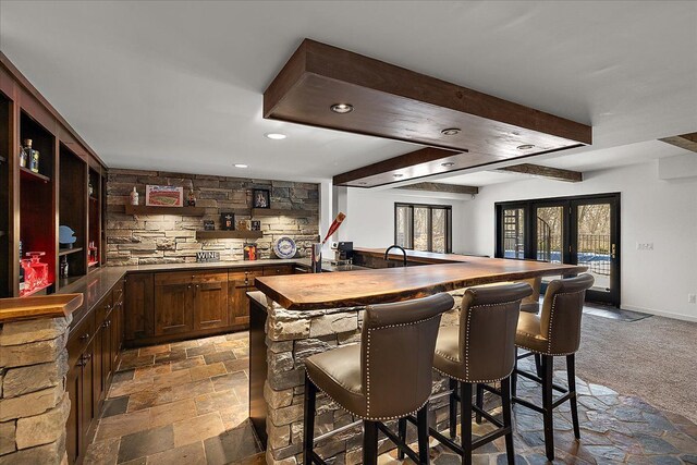 1194 Eagle Nest, Milford, MI 48381 - indoor wet bar featuring recessed lighting, stone tile floors, french doors, and beamed ceiling