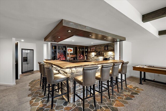 1194 Eagle Nest, Milford, MI 48381 - indoor wet bar featuring stainless steel fridge, carpet, baseboards, beam ceiling, and recessed lighting