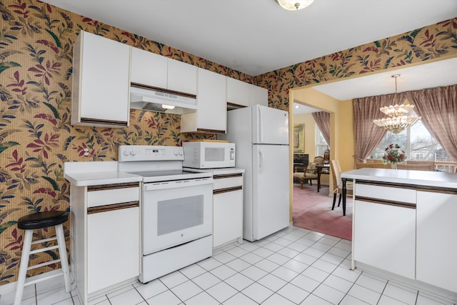 31052 Silverdale Dr, Novi, MI 48377 - kitchen with white appliances, white cabinets, under cabinet range hood, wallpapered walls, and a notable chandelier