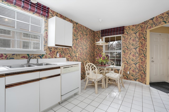 31052 Silverdale Dr, Novi, MI 48377 - kitchen with light tile patterned floors, white dishwasher, a sink, white cabinetry, and wallpapered walls