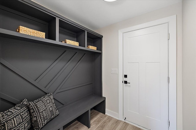 mudroom featuring light wood-style flooring and baseboards