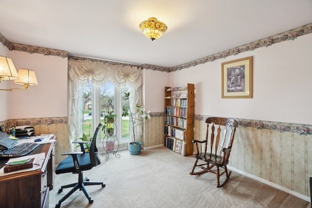 home office with wood walls, a wainscoted wall, and carpet flooring