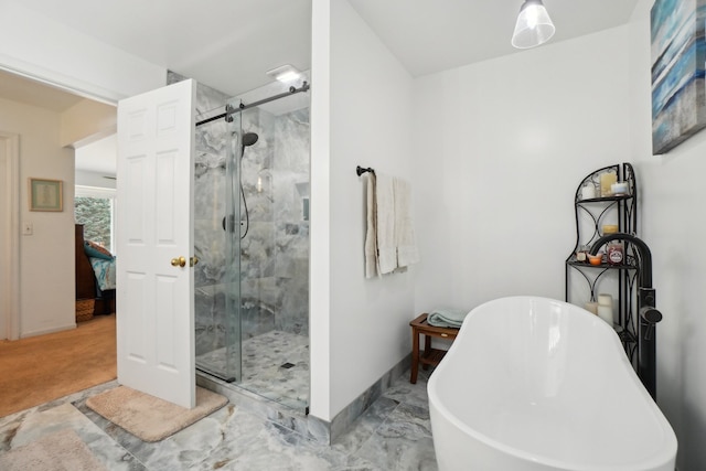 full bath with a shower stall, baseboards, and a soaking tub