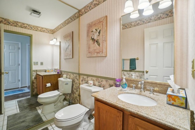 bathroom featuring toilet, wallpapered walls, vanity, and tile patterned flooring