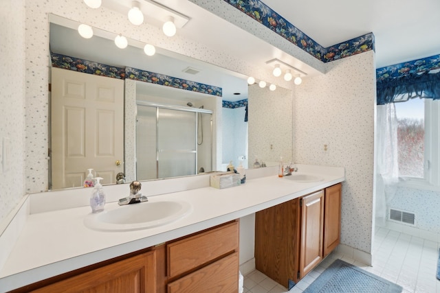 full bathroom featuring wallpapered walls, tile patterned flooring, visible vents, and a sink