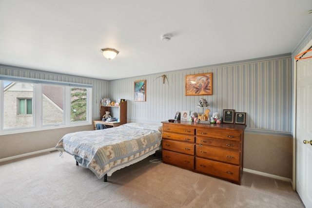 carpeted bedroom featuring baseboards
