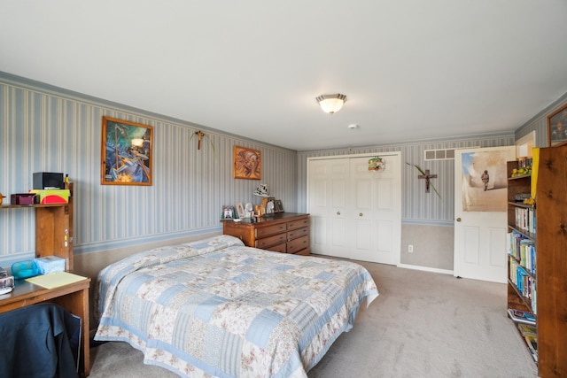 carpeted bedroom with a closet, baseboards, and wallpapered walls