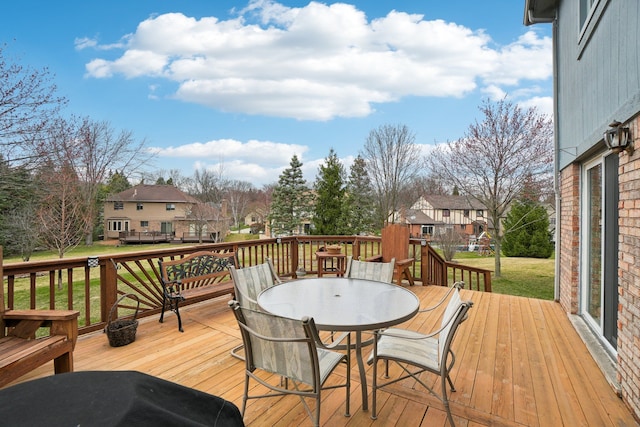 deck featuring outdoor dining space and a residential view