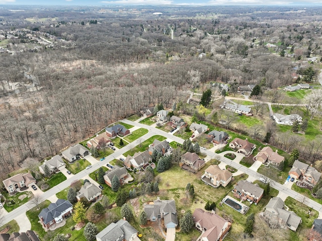 drone / aerial view featuring a residential view and a forest view