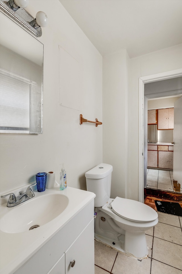 bathroom featuring tile patterned flooring, vanity, and toilet