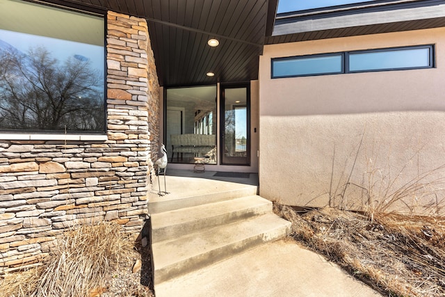 10485 Hadley Rd, Gregory, MI 48137 - view of exterior entry featuring stucco siding and stone siding