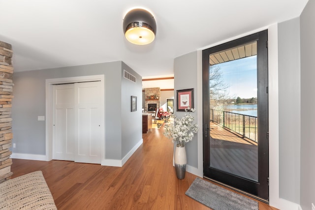 10485 Hadley Rd, Gregory, MI 48137 - foyer entrance featuring baseboards, wood finished floors, a fireplace, and visible vents