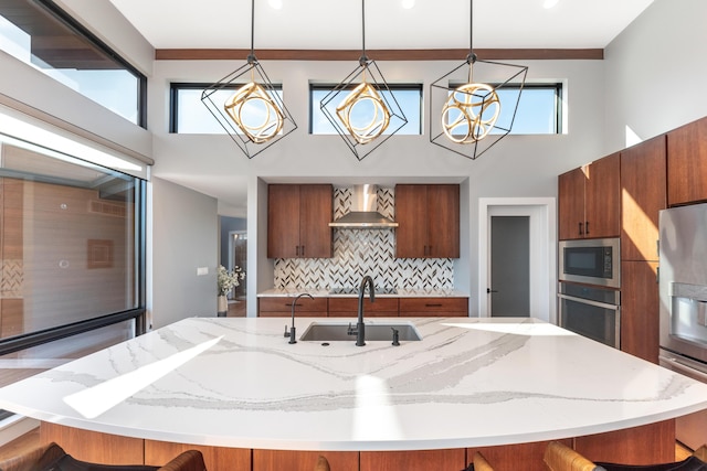 10485 Hadley Rd, Gregory, MI 48137 - kitchen with a notable chandelier, a kitchen breakfast bar, wall chimney range hood, appliances with stainless steel finishes, and a sink