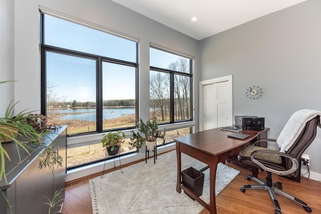 10485 Hadley Rd, Gregory, MI 48137 - office space featuring baseboards, recessed lighting, a high ceiling, a water view, and wood finished floors