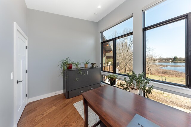 10485 Hadley Rd, Gregory, MI 48137 - office area featuring a water view, baseboards, recessed lighting, and wood finished floors
