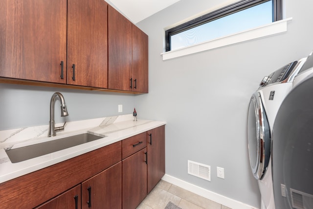 10485 Hadley Rd, Gregory, MI 48137 - laundry room with light tile patterned floors, visible vents, independent washer and dryer, cabinet space, and a sink