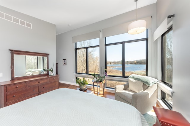 10485 Hadley Rd, Gregory, MI 48137 - bedroom with a water view, baseboards, and wood finished floors