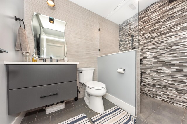 10485 Hadley Rd, Gregory, MI 48137 - full bath featuring toilet, tile walls, a walk in shower, vanity, and tile patterned flooring