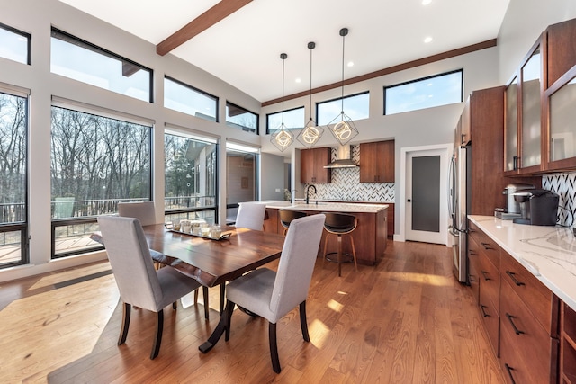 10485 Hadley Rd, Gregory, MI 48137 - dining room with light wood-style floors, a high ceiling, and beam ceiling