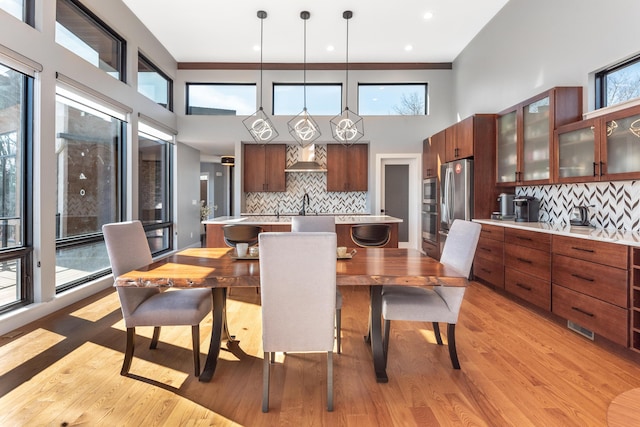 10485 Hadley Rd, Gregory, MI 48137 - dining space featuring visible vents, light wood-type flooring, and a high ceiling