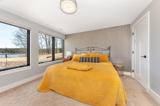 10485 Hadley Rd, Gregory, MI 48137 - bedroom featuring carpet floors, an accent wall, baseboards, and a water view