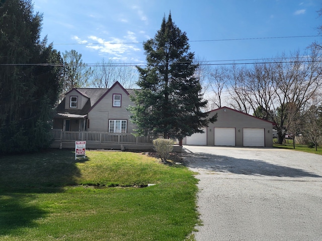 view of front of property featuring a front lawn, an outdoor structure, and a garage