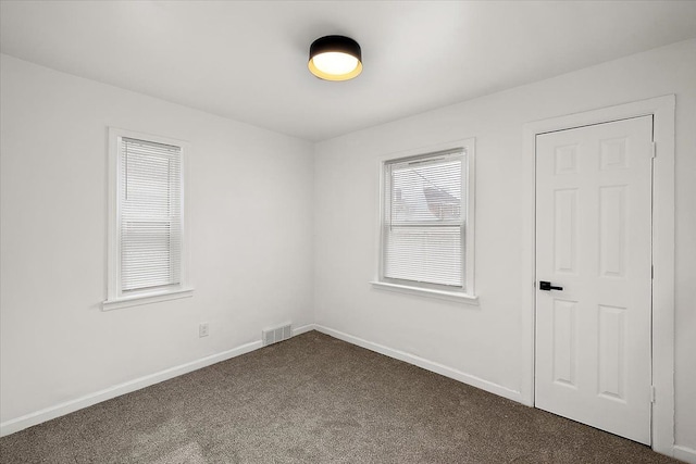 18645 Cherrylawn St, Detroit, MI 48221 - spare room with baseboards, dark colored carpet, and visible vents