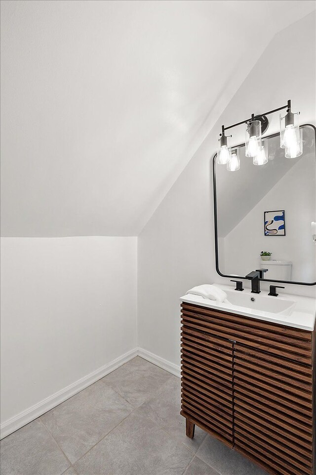 18645 Cherrylawn St, Detroit, MI 48221 - bathroom with vanity, baseboards, and vaulted ceiling