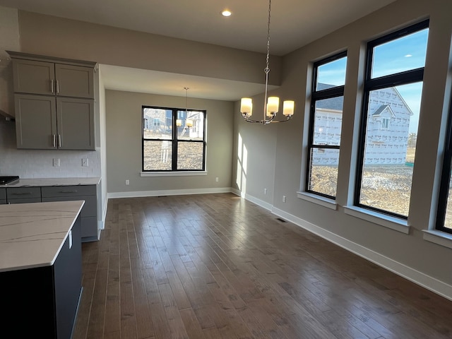 60671 Town Square St, New Hudson, MI 48165 - unfurnished dining area with visible vents, baseboards, an inviting chandelier, dark wood-style floors, and recessed lighting