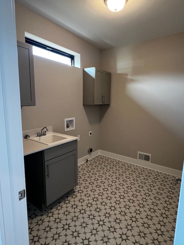 60671 Town Square St, New Hudson, MI 48165 - laundry room featuring visible vents, baseboards, a sink, hookup for an electric dryer, and cabinet space