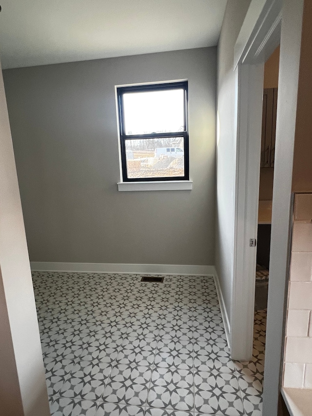 60671 Town Square St, New Hudson, MI 48165 - unfurnished room featuring visible vents, baseboards, and light floors