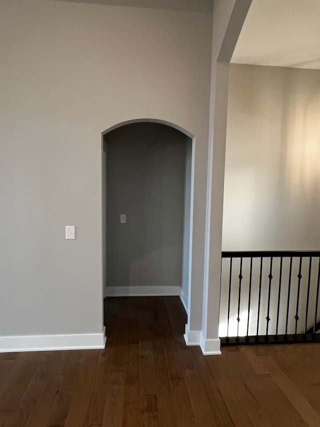 60671 Town Square St, New Hudson, MI 48165 - hall featuring arched walkways, wood finished floors, and baseboards