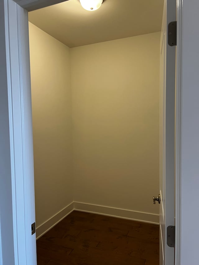60671 Town Square St, New Hudson, MI 48165 - spare room with dark wood-style flooring and baseboards