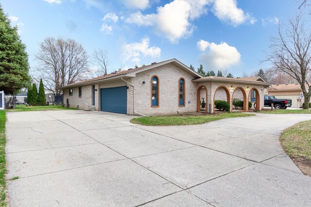 46498 Houghton Dr, Shelby, MI 48315 - view of front facade with driveway, a garage, and brick siding