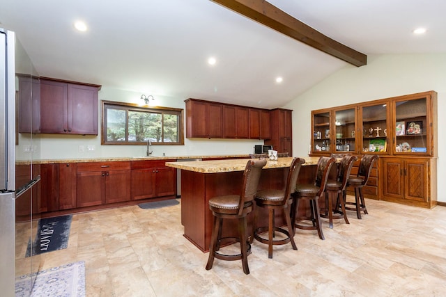 46498 Houghton Dr, Shelby, MI 48315 - kitchen with freestanding refrigerator, a breakfast bar, a kitchen island, a sink, and vaulted ceiling with beams