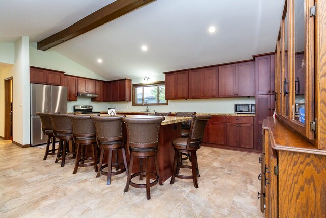 46498 Houghton Dr, Shelby, MI 48315 - kitchen with a center island, under cabinet range hood, a kitchen bar, and stainless steel appliances