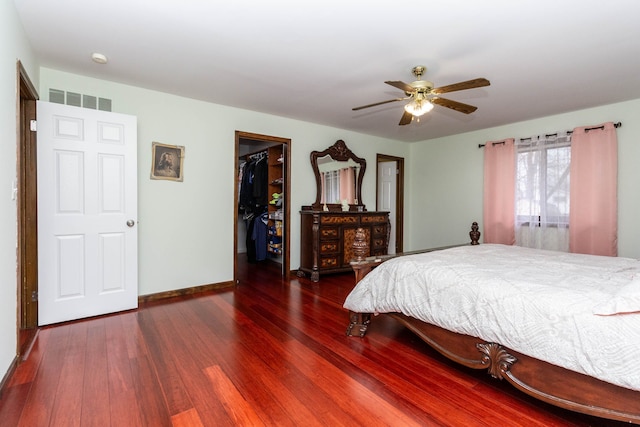 46498 Houghton Dr, Shelby, MI 48315 - bedroom with visible vents, baseboards, a closet, a walk in closet, and wood finished floors