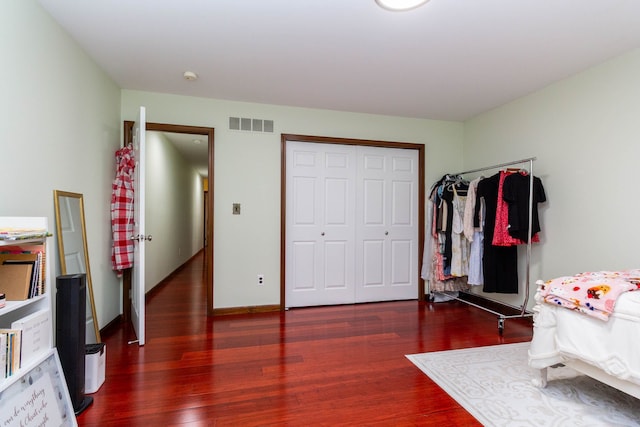 46498 Houghton Dr, Shelby, MI 48315 - bedroom featuring visible vents, baseboards, a closet, and wood finished floors