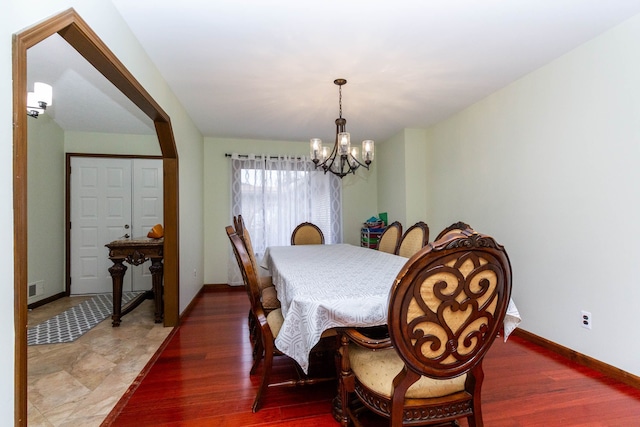 46498 Houghton Dr, Shelby, MI 48315 - dining area featuring wood finished floors, an inviting chandelier, baseboards, and visible vents