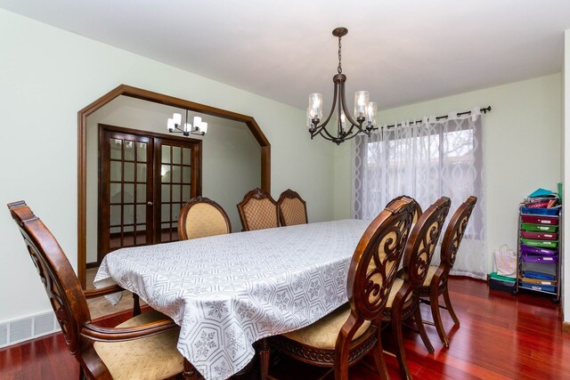 46498 Houghton Dr, Shelby, MI 48315 - dining space featuring visible vents, an inviting chandelier, and wood finished floors