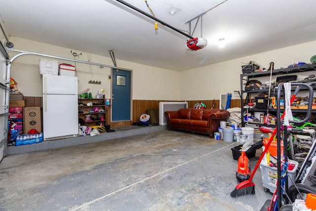 46498 Houghton Dr, Shelby, MI 48315 - garage with a garage door opener and freestanding refrigerator