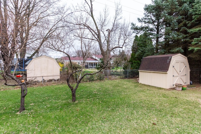 46498 Houghton Dr, Shelby, MI 48315 - view of yard with a fenced backyard, an outdoor structure, a trampoline, and a shed