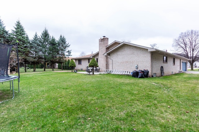 46498 Houghton Dr, Shelby, MI 48315 - view of yard featuring a trampoline, a patio area, and an attached garage